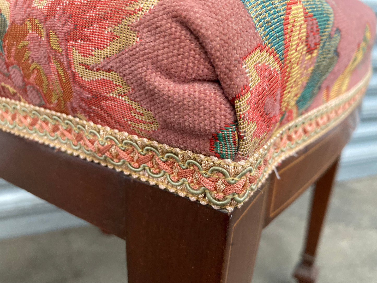 Single antique dining chair with floral seat and gold inlaid trim on back rest