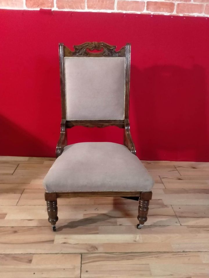 Carved oak antique upholstered nursing chair on castors
