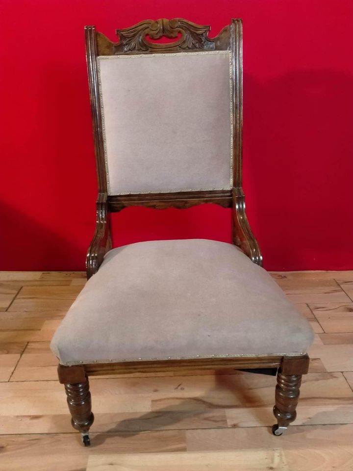 Carved oak antique upholstered nursing chair on castors