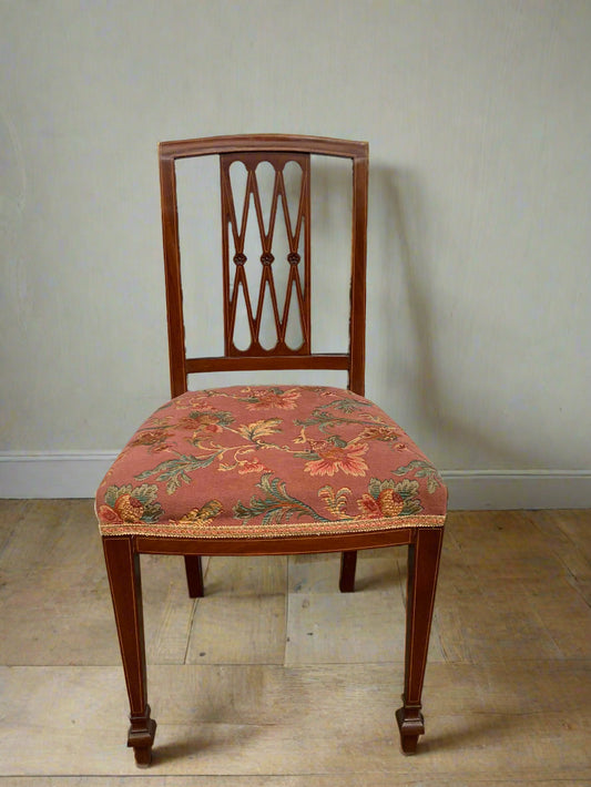 Single antique dining chair with floral seat and gold inlaid trim on back rest