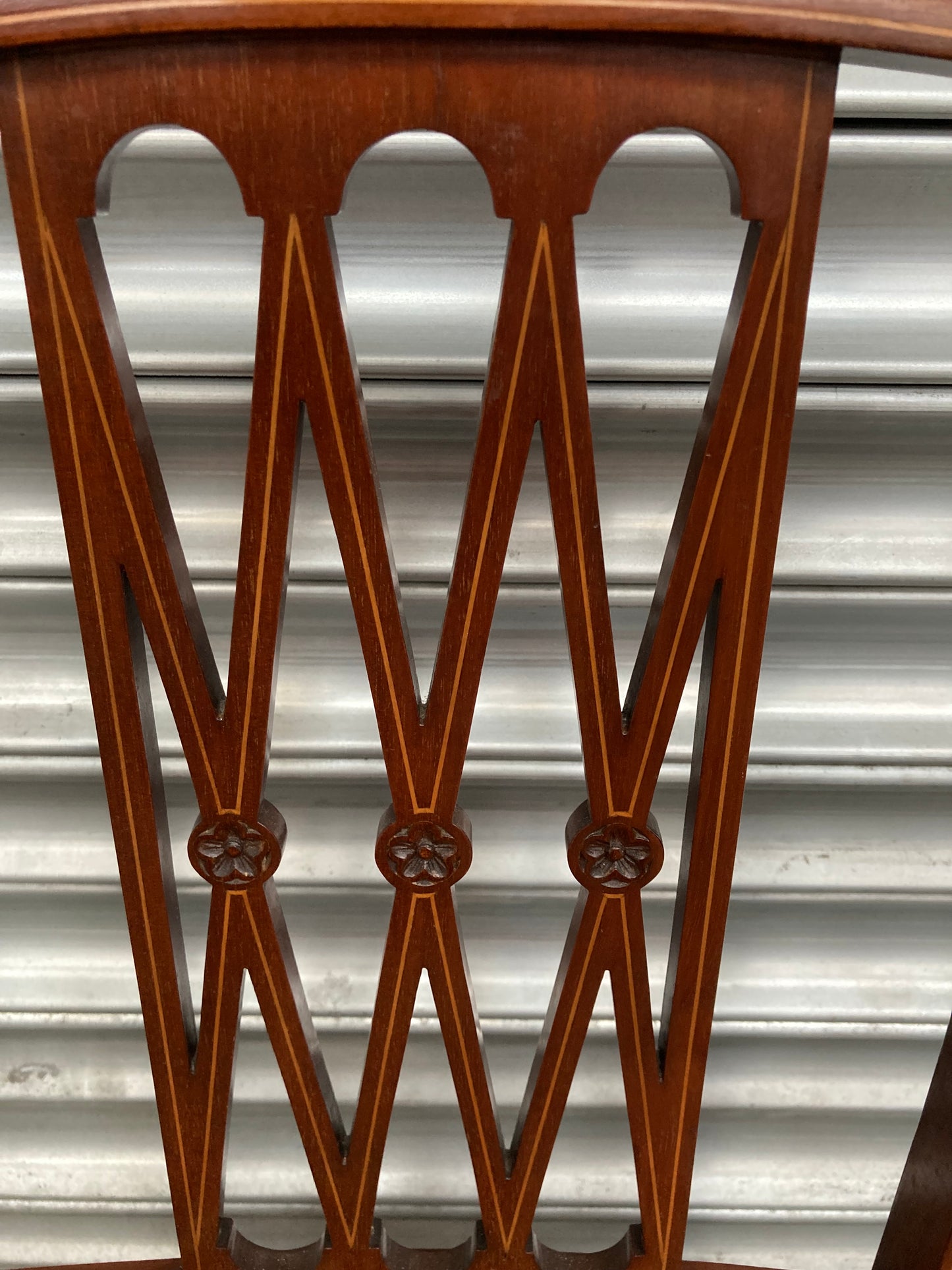 Single antique dining chair with floral seat and gold inlaid trim on back rest